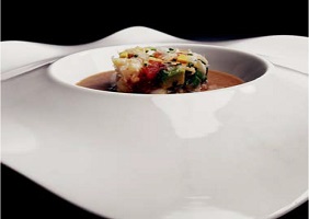 Timbal de carne de centolla con sopa de pan de bronaFoto de Timbal de carne de centolla con sopa de pan de bronaes